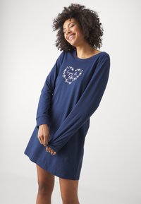 Navy blue long-sleeve nightdress in soft fabric with a round neckline and floral heart graphic featuring the text "Enjoy the little things."
