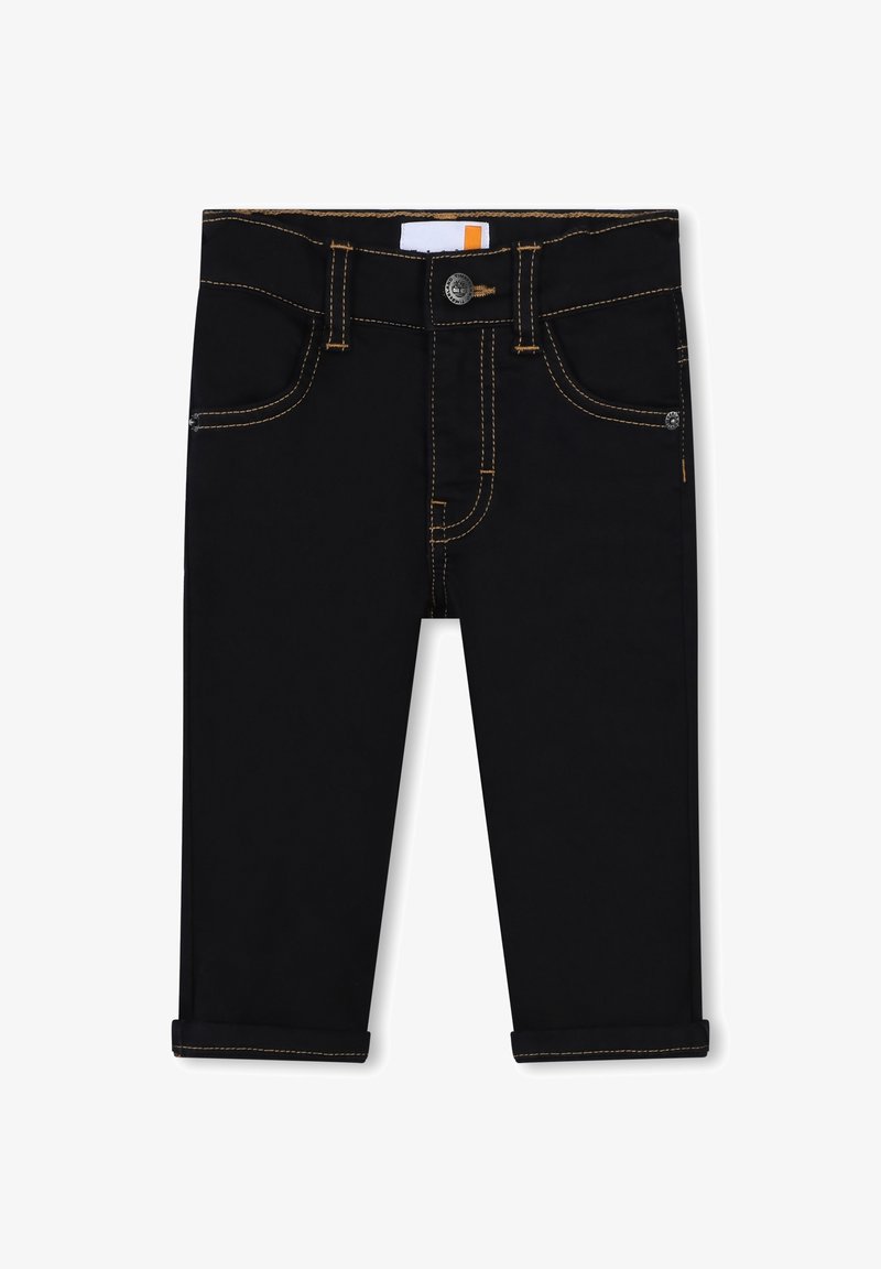 Pantalons en denim noir à coupe fuselée, avec des coutures dorées, fermeture à bouton et ourlets retroussés. Comprend des poches avant et arrière.