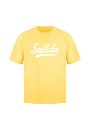 T-shirt di cotone giallo con maniche corte, con logo in bianco "Smilodox" sulla parte anteriore. Collo a giro classico.