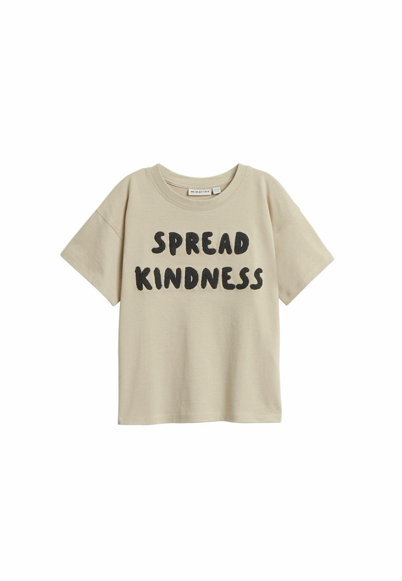 Beige bomullst-shirt med kort ärm och rund halsringning. Framsidan har texten "SPRIDA VÄNLIGHET" i fetstil, mörka bokstäver.