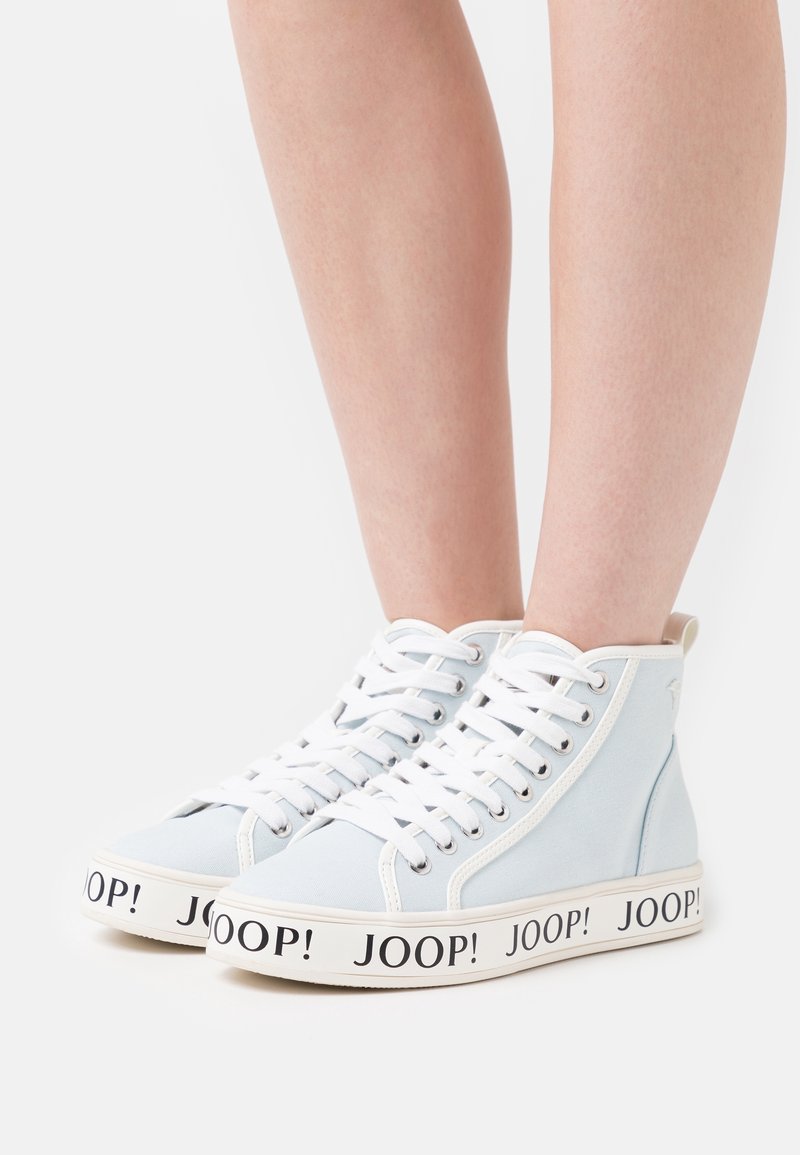 Light blue high-top sneakers with white laces, featuring a rubber sole and bold black "JOOP!" branding around the midsole.