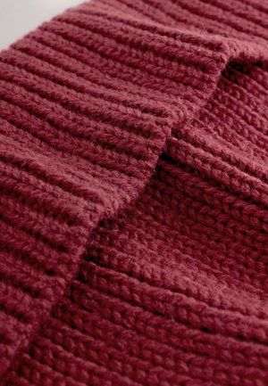 Tessuto bordeaux lavorato a maglia con motivo a coste, texture morbida e aspetto spesso e accogliente con fibre e punti visibili.