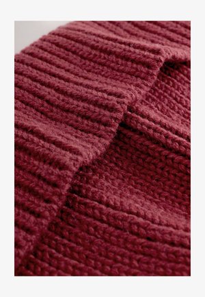 Tessuto bordeaux lavorato a maglia con motivo a coste, texture morbida e aspetto spesso e accogliente con fibre e punti visibili.