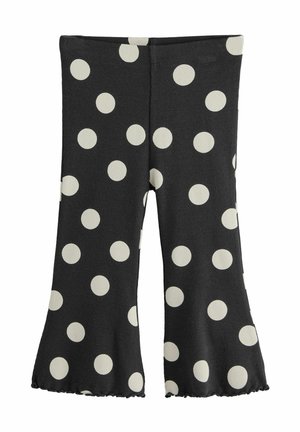 Mustat leveälahkeiset legginsit, joissa on suuria valkoisia pilkkuja. Vaahtokarkkimaisesti ribattu pinta ja venyvä materiaali. Helman reunassa on pieni röyhelöyksityiskohta.