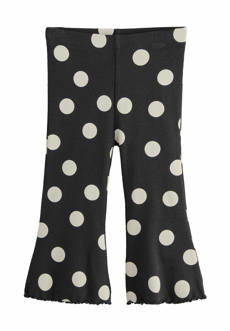 Leggings neri a palazzo con grandi pois bianchi. Tessuto a coste e materiale elasticizzato. L'orlo presenta un leggero dettaglio arricciato.