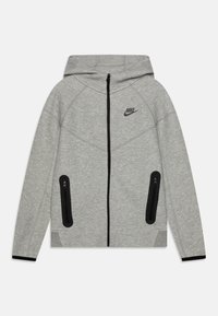 Šedá Nike mikina na zip s texturovaným povrchem, černými zipy, dvěma kapsami na zip a kapucí se šňůrkami. Logo na levé straně hrudi.