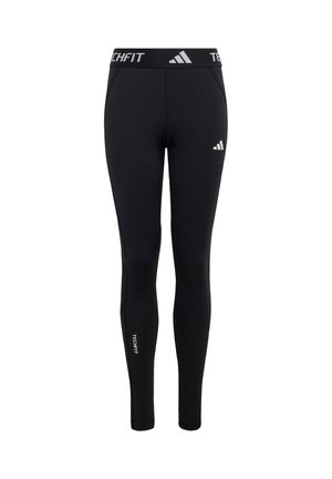 Leggings ajustados negros Adidas Techfit con logo en el muslo izquierdo, texto "TECHFIT" en la cintura y parte inferior de la pierna derecha, estilo slim fit.