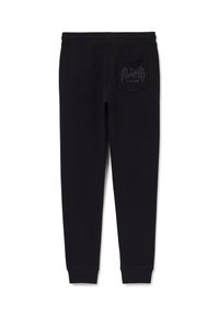 Schwarze Sweatpants aus weichem Stoff mit tapered Fit. Sie verfügen über eine Gesäßtasche, auf der "ALONE in the dark" in einer stilisierten Schriftart gedruckt ist.