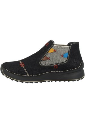 Black slip-on shoes with textured material, herringbone fabric accents, colorful fish patterns, red hardware, and a thick rubber sole.