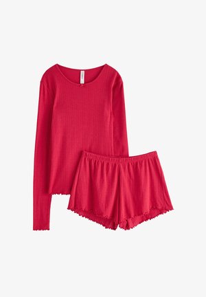 Top de manga larga con canalé rojo y escote redondeado, combinado con pantalones cortos rojos a juego. Los pantalones cortos presentan un dobladillo con volantes y una cintura elástica.