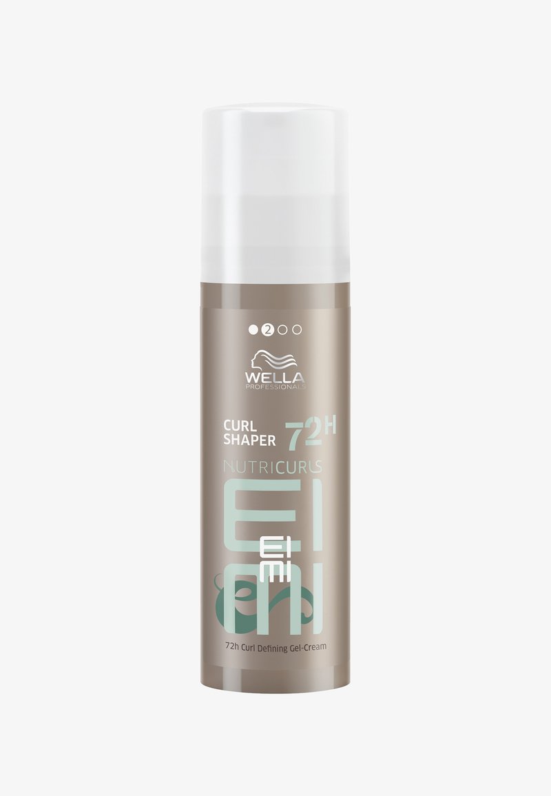 Gel-crème définissant les boucles dans un flacon cylindrique, mat beige avec une pompe blanche. L'étiquette présente des accents turquoise et le logo de la marque.