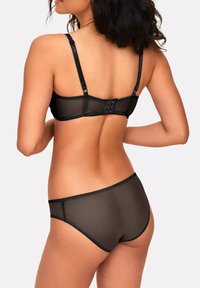 Black lingerie set featuring sheer mesh fabric, adjustable straps, and a hook-and-eye closure at the back. Simple design with smooth texture.