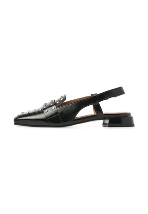 Black patent leather slingback flat shoe with silver studs and a low block heel, shown from the side on a white background.