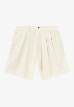 Pantalones cortos color crema con un diseño entallado, que presentan pliegues, bolsillos laterales y un cierre de botón en la parte frontal. Tejido suave y liviano.
