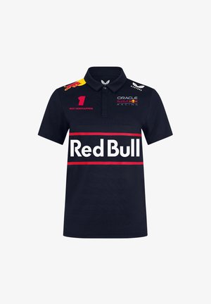 Granatowa koszulka polo z kołnierzykiem, z dużym białym logo "Red Bull", czerwonymi akcentami oraz logo sponsorów na rękawach. Lekki materiał.