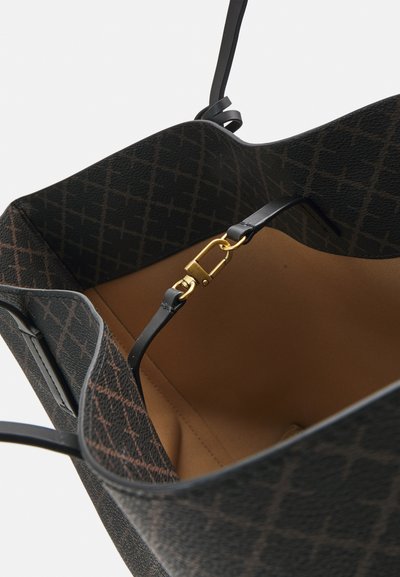 Black textured tote bag with a geometric pattern, featuring a tan interior and a gold metal clasp on a black strap.