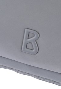 Gray textile pouch with a textured surface, featuring a raised, gray letter "B" as a notable detail.