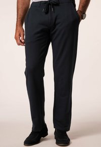 Navy blue, textured trousers with an elastic waistband and drawstring. Features side pockets and a relaxed fit. Suitable for casual wear.