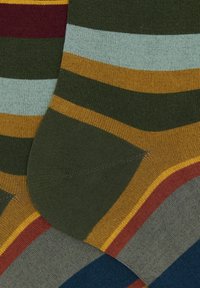 Multicolored socks featuring green, blue, maroon, yellow, and light blue horizontal stripes; made from a soft, stretchy knit fabric.