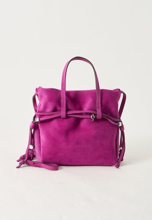 Soft suede purple handbag with double top handles, side straps, and a decorative cord wrapped around the front on a plain light background.
