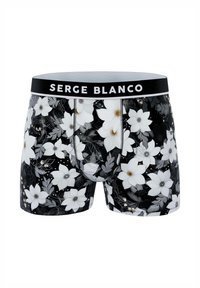 Boxer noir à motif floral avec des fleurs blanches, des feuilles vertes, une ceinture noire contrastante avec le logo "SERGE BLANCO" et une coupe ajustée.