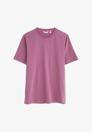 Kratka majica s kratkimi rokavi v mauve barvi, narejena iz mehke bombažne tkanine. Okrogla izreza in ravna kroja. Ima majhen oznako blagovne znamke na robu.