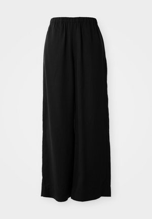 Pantalons larges noirs en tissu doux avec une taille élastique. Présente une coupe droite et des fentes latérales pour une meilleure ventilation.
