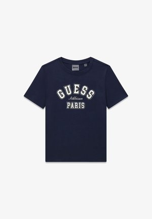 T-shirt en coton bleu marine à manches courtes. Présente les textes "GUESS" et "Paris" en blanc avec des accents en pointillé. Col rond.
