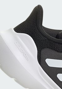 Black athletic shoe with mesh upper, white cushioned sole, and white logo accents. Features 'CLOUDFOAM' embossed on outer sole.