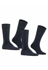 Calze a girocollo di un blu scuro, realizzate in un tessuto morbido, con polsini a coste e punte rinforzate, caratterizzate da una semplice texture uniforme. Set di tre paia.