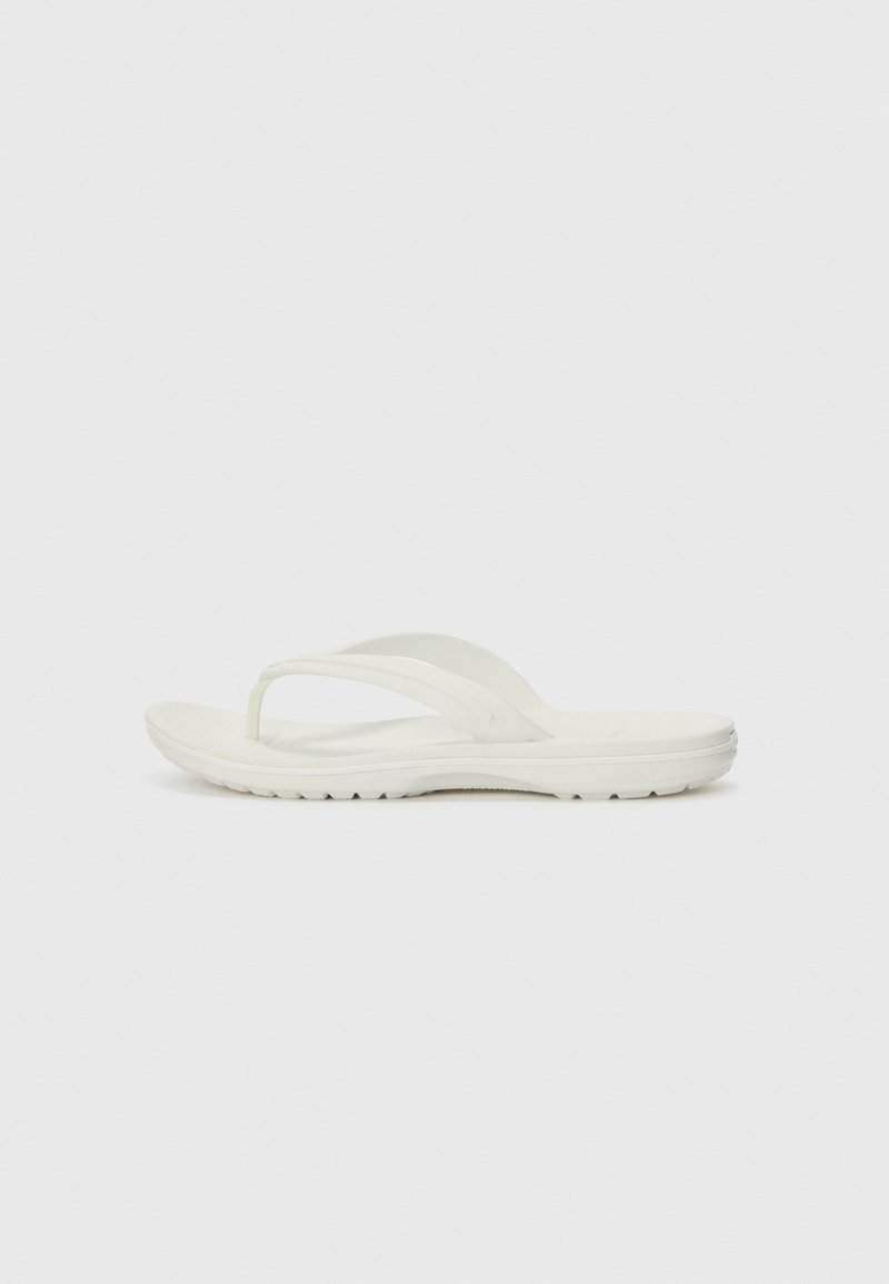 White flip-flop featuring a minimalist design, made from soft rubber material, with a flat sole and a Y-shaped strap for support.