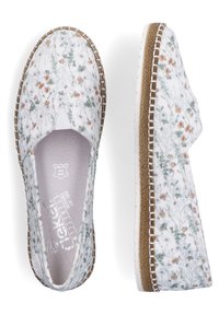 Chaussures blanches sans lacets avec imprimé floral marron et vert, semelle intermédiaire tressée marron, coutures blanches et semelle extérieure en caoutchouc blanc, vues de dessus et de côté.