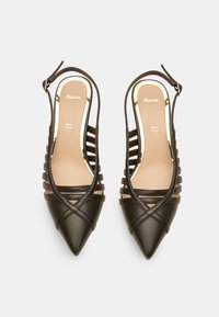 Escarpins slingbacks noirs avec bouts pointus, côtés ouverts et brides croisées. Texture en cuir lisse avec une semelle intérieure beige et un logo de la marque.