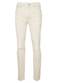 Beżowe dżinsy z denimu o dopasowanym kroju, z przetarciami na kolanach, pięcioma kieszeniami oraz klasycznym zapięciem na guzik i suwak.