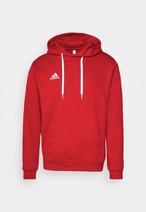 Rode hoodie gemaakt van katoen, met witte trekkoorden, een voorzak en een geborduurd wit Adidas-logo op de linkerborst.
