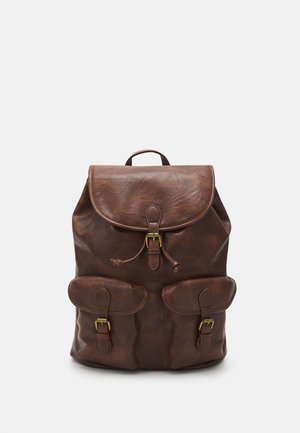 Brown leather backpack with a flap top, two front pockets, and gold-tone hardware. Features a textured finish and adjustable straps.