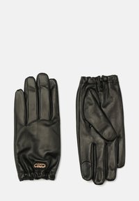 Schwarze Lederhandschuhe mit glatter Textur, fünf Fingern und elastischen Bündchen. Merkmale ein kleines goldenes Emblem am Handgelenk.