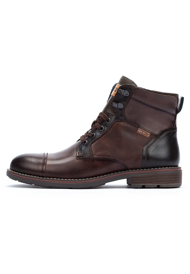 Brown leather ankle boot with textured fabric panels, rounded toe, lace-up design, and contrasting dark accents. Sturdy rubber sole.
