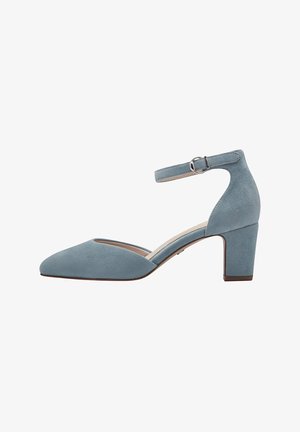 Blue suede ankle strap heels with a pointed toe and a moderate block heel, featuring a cut-out side detail.