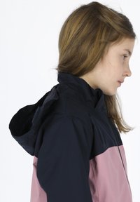 Water-resistant jacket with a black top half and pink lower half. Features a hood, zippered front, and smooth texture.