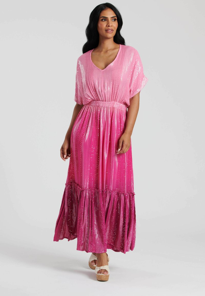 Rosa maxiklänning med V-ringning, draperade ärmar och en tiered volangsläp. Tillverkad av lätt tyg med paljetter för extra textur.