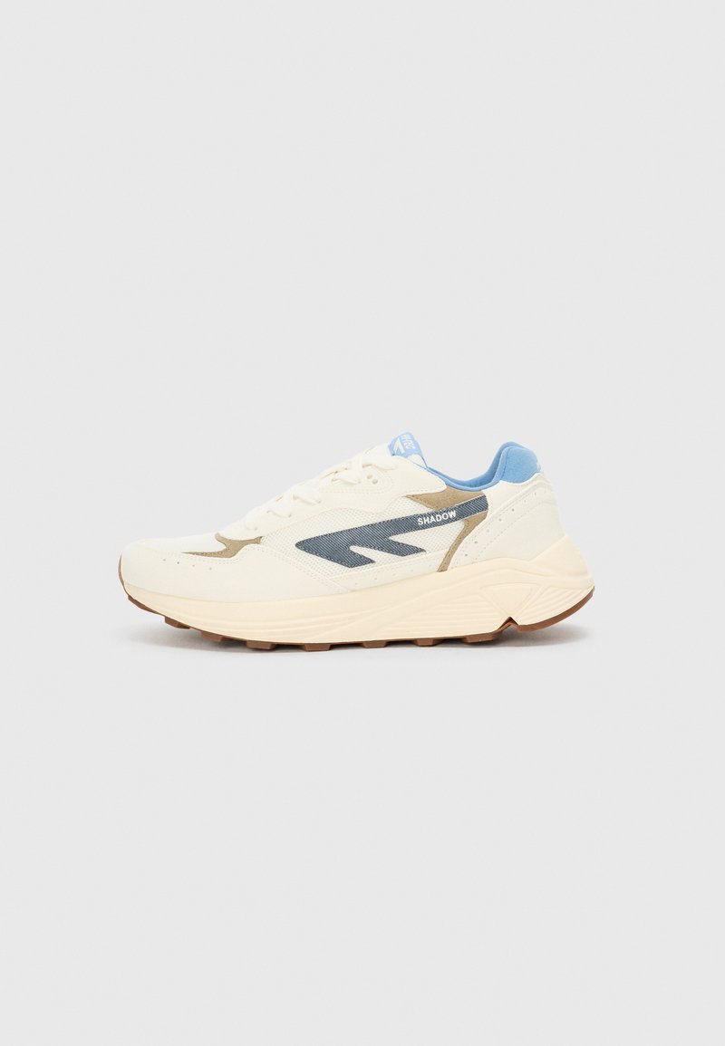 White athletic shoe with light blue accents, featuring a mesh upper, textured overlays, and a durable rubber sole. Design includes side logo.