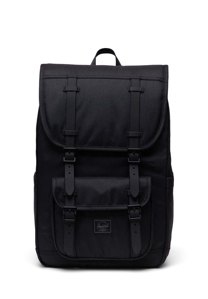 Black fabric backpack with a rectangular shape, adjustable straps, front flap, two buckle closures, and a small brand patch.