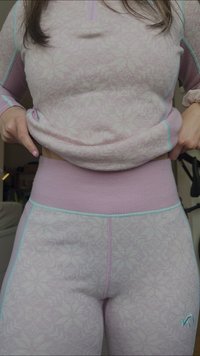 Lys rosa treningssett med mønstret topp med halvlange glidelås og matchende høywaistede leggings med turkise detaljer og sømmer.