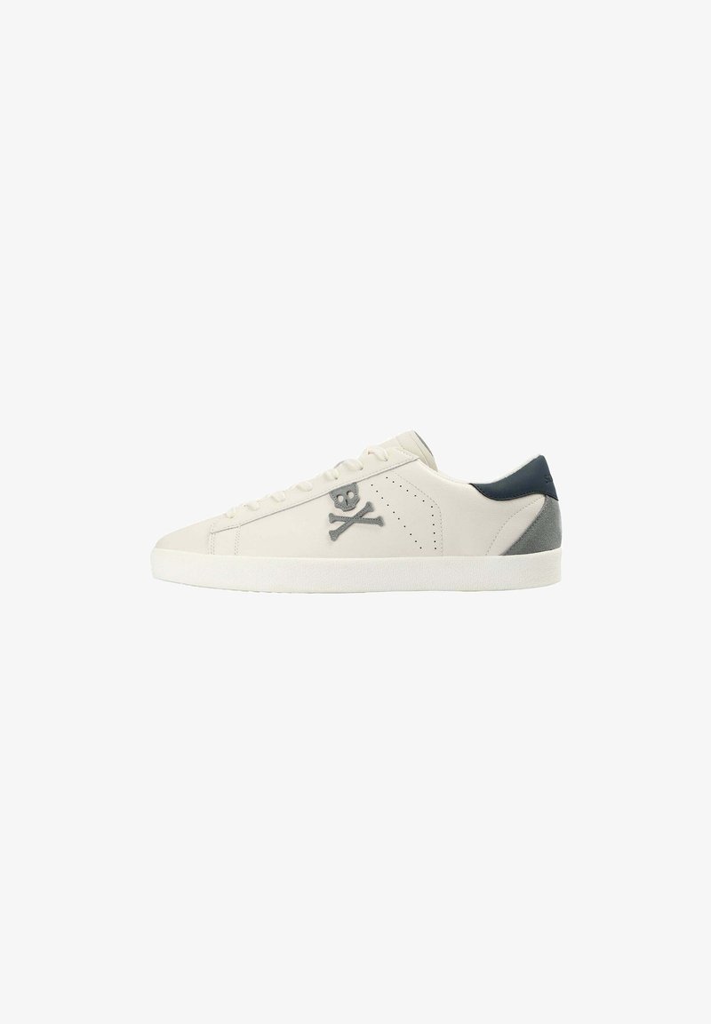 White sneaker with gray skull and crossbones logo, smooth leather upper, perforated sides, and a blue suede heel accent. Flat white sole.