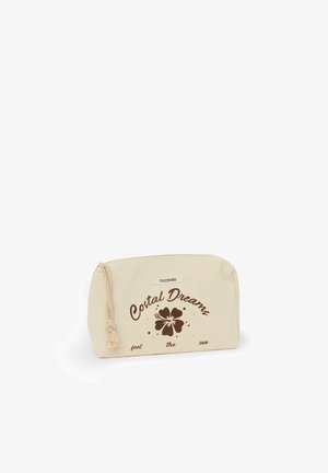 Pochette en tissu beige avec tirette en corde, fleur d'hibiscus marron et texte "Costal Dreams feel the sea" sur le devant.