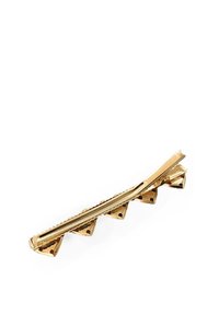 Goldfarbener Haarklammer mit Zickzack-Design, das strukturierte Rillen und dreieckige Akzente aufweist und einen sicheren Halt bietet.