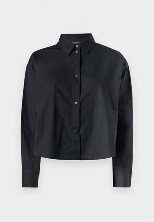 Camicia nera cropped con bottoni, realizzata in tessuto liscio, con colletto a punta e maniche lunghe, caratterizzata da bottoni visibili sul davanti.