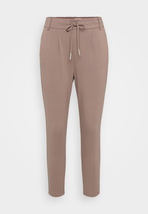 Hellbraune, taillierte Hose aus weichem Material. Verfügt über einen elastischen Bund mit Kordelzug, Falten und umgeschlagenen Knöcheln.
