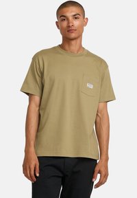 Olive green cotton t-shirt with short sleeves, a crew neck, and a left chest pocket featuring a small label. Simple and versatile design.